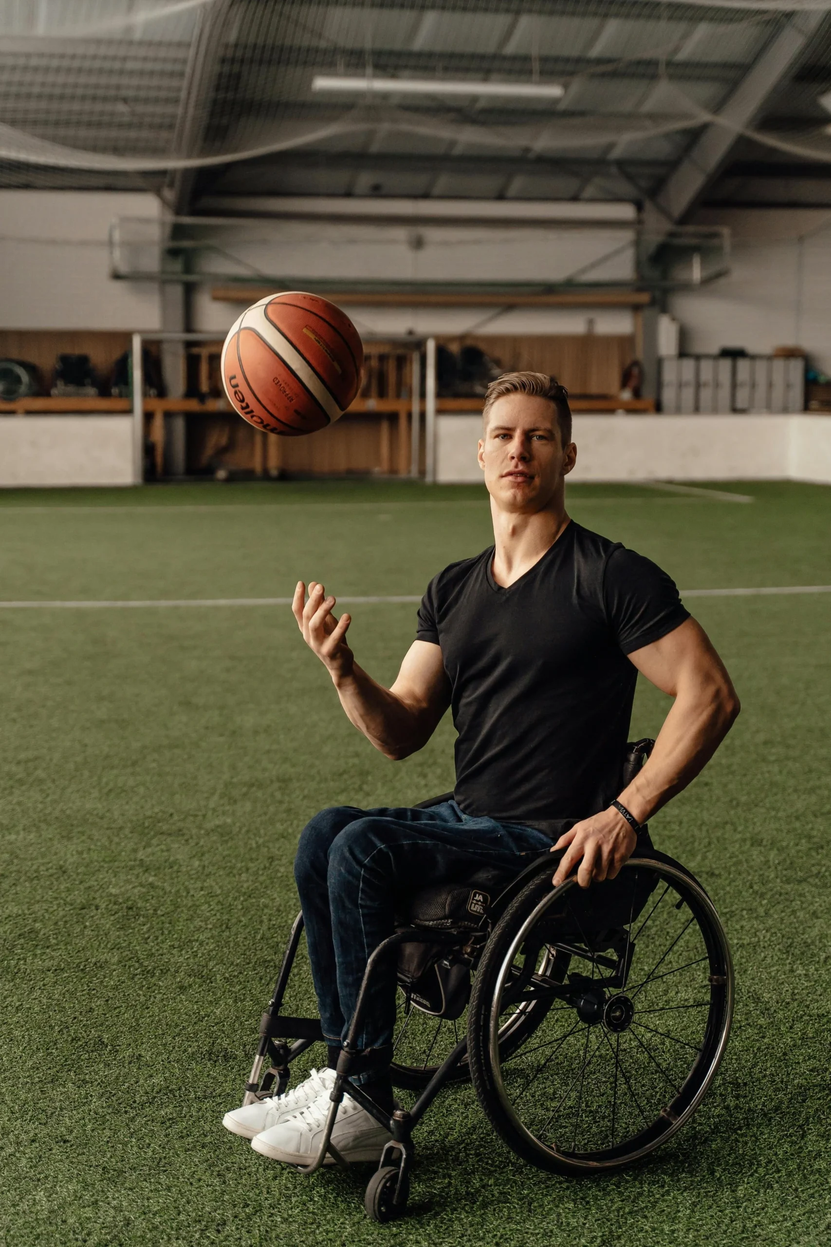 Man in wheelchair, spinning basketball